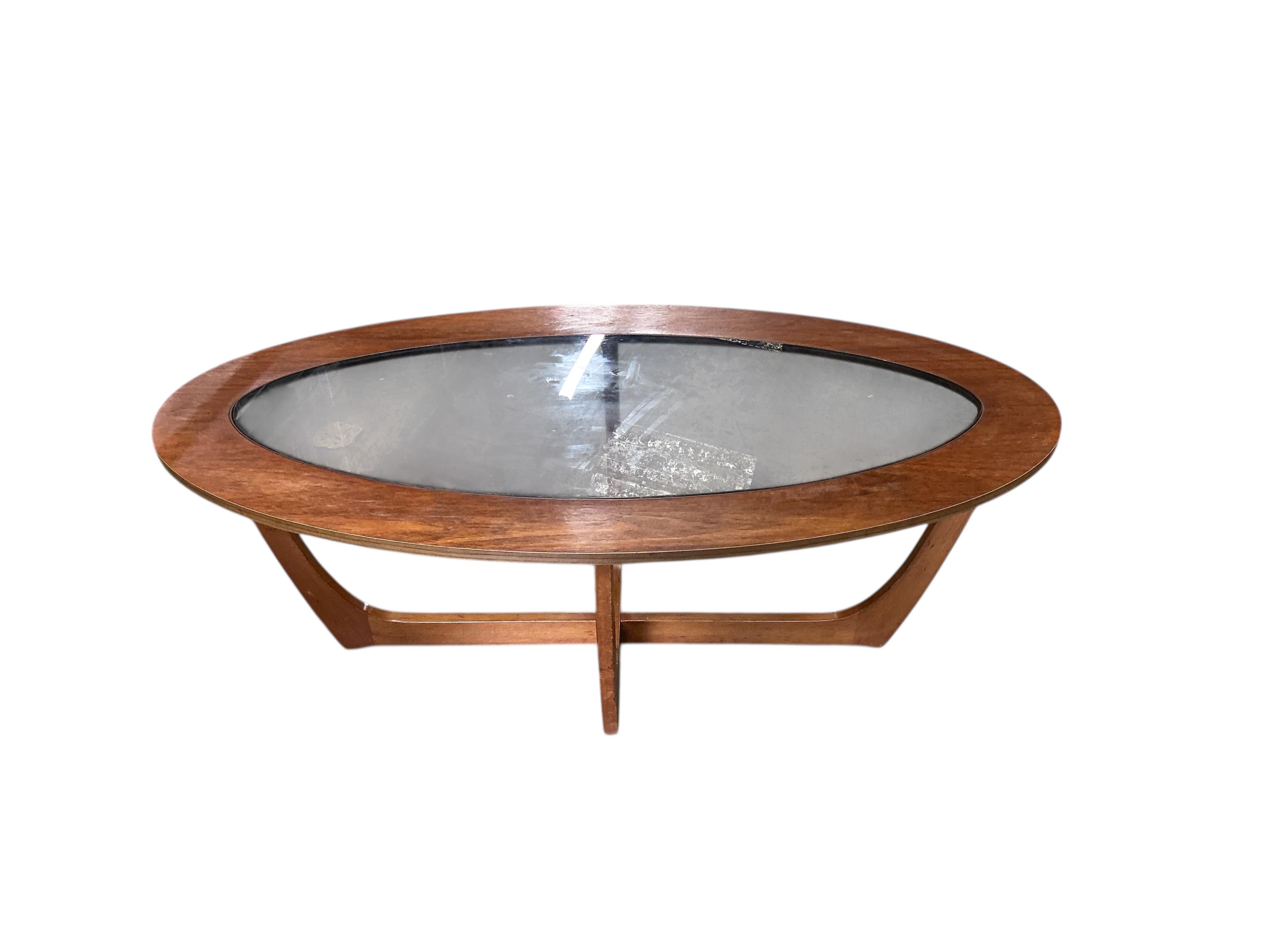 A mid century teak oval glass top coffee table, width 106cm, depth 53cm, height 41cm